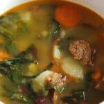 Kale simmers with sausage, garlic, onions and more for the Best Portuguese Kale Soup recipe.