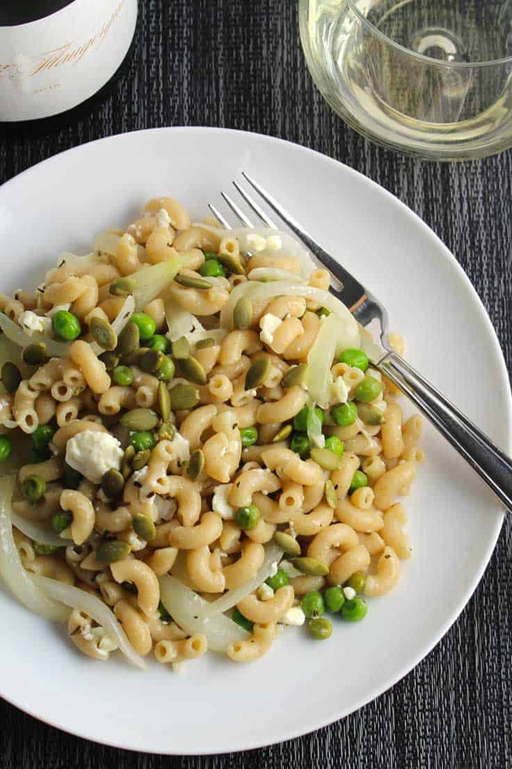 frozen peas, an onion and some feta cheese are all you need to make this quick pasta dish on a busy weeknight!