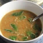 lentil soup with spinach in a white bowl