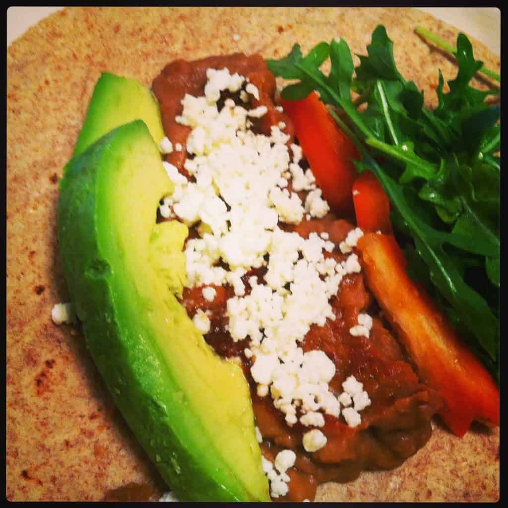 soft tacos with refried beans, avocado and other vegetables