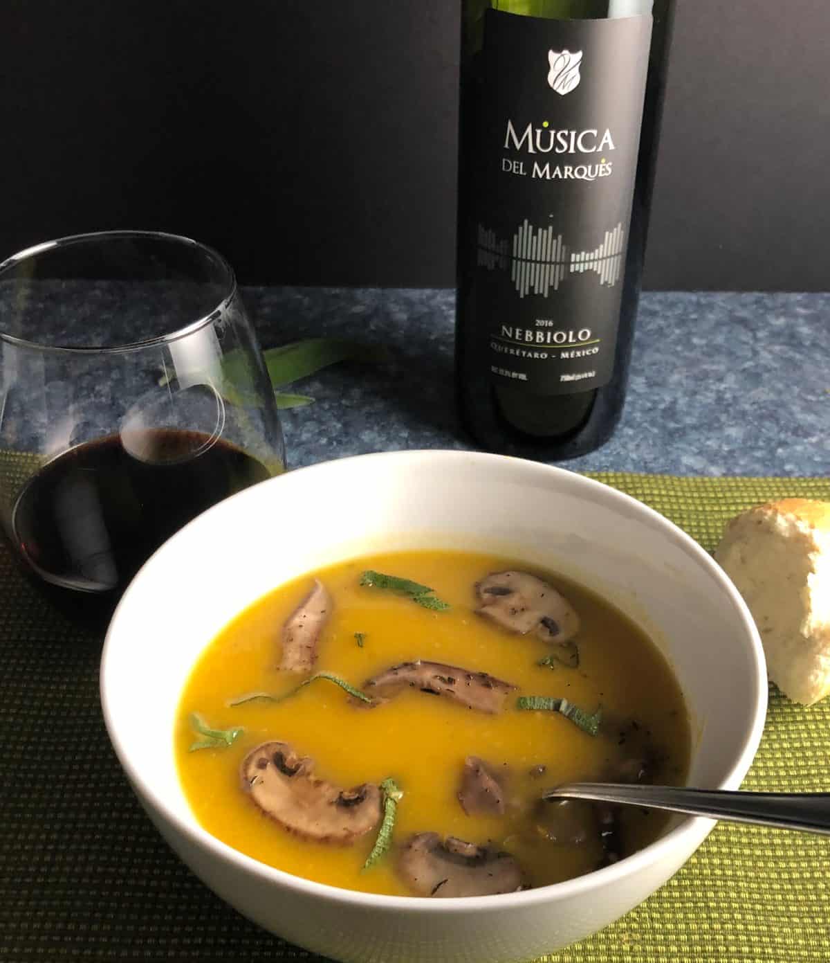 bowl of butternut squash soup paired with a red wine from Mexico.