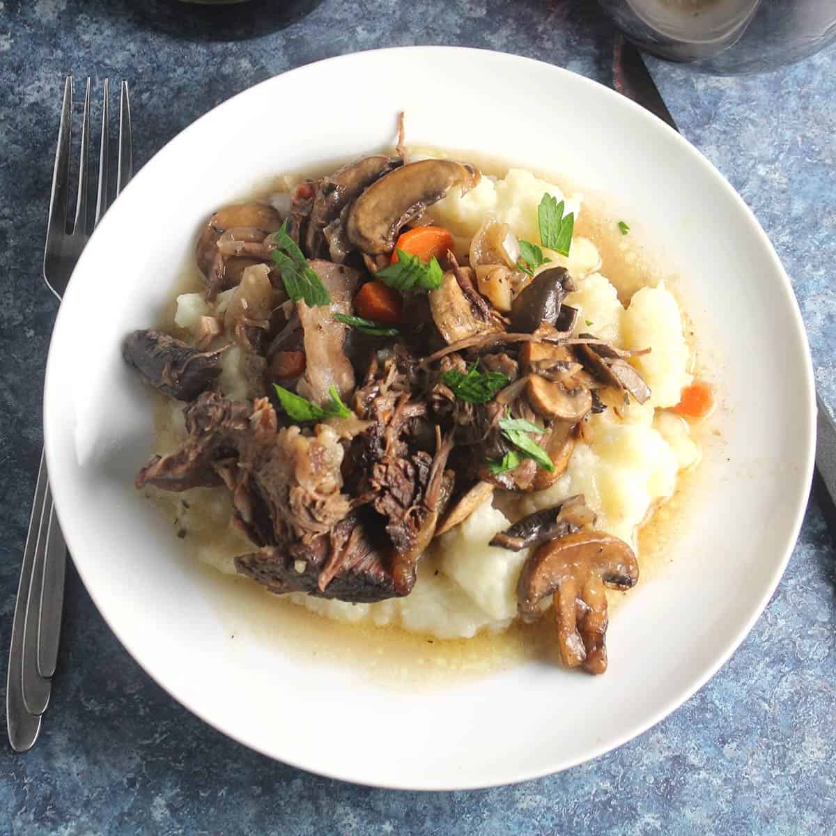 red wine braised short ribs served over mashed potatoes.
