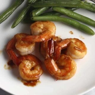 sautéed shrimp on a plate with green beans