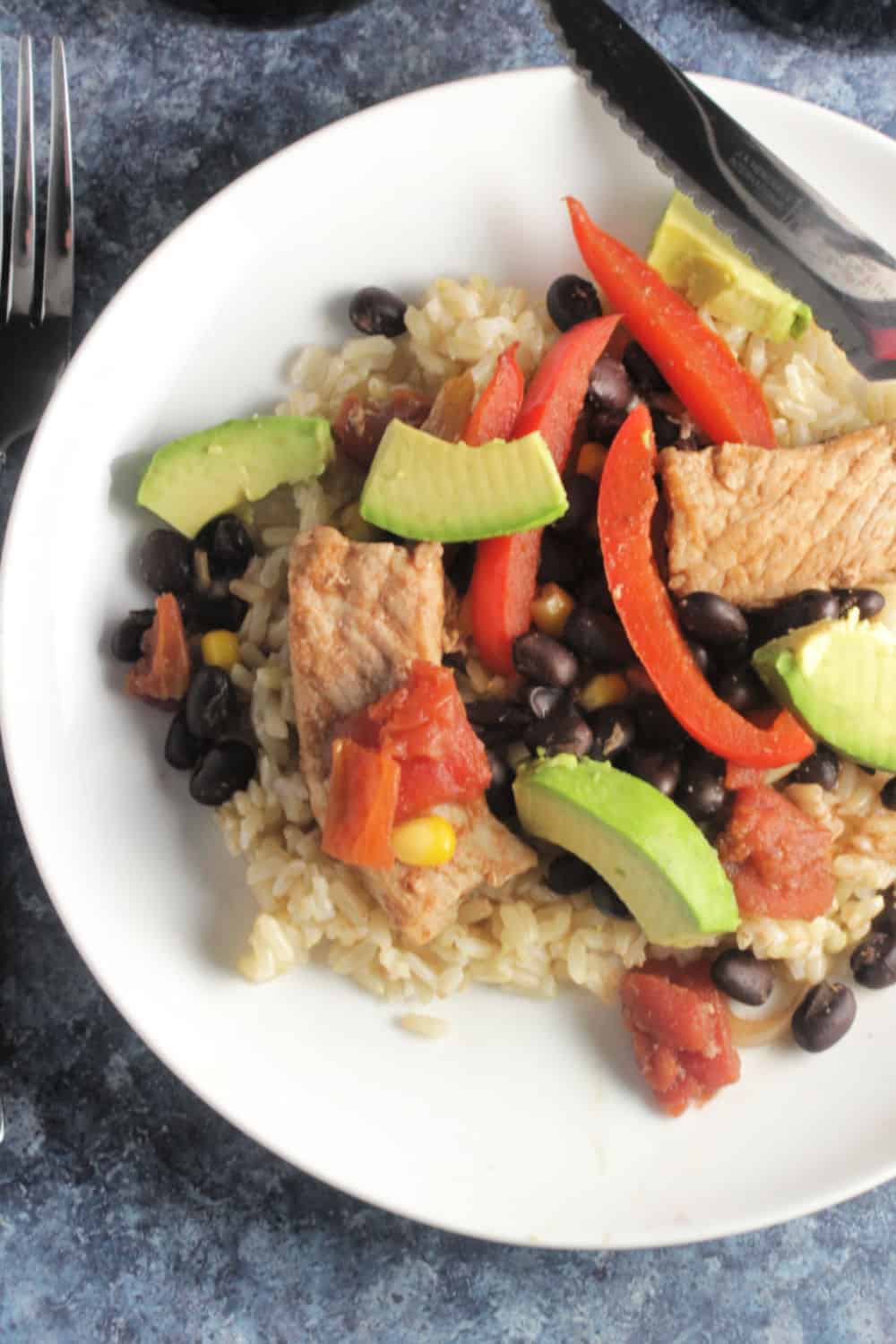 skillet pork and black beans on a white plate