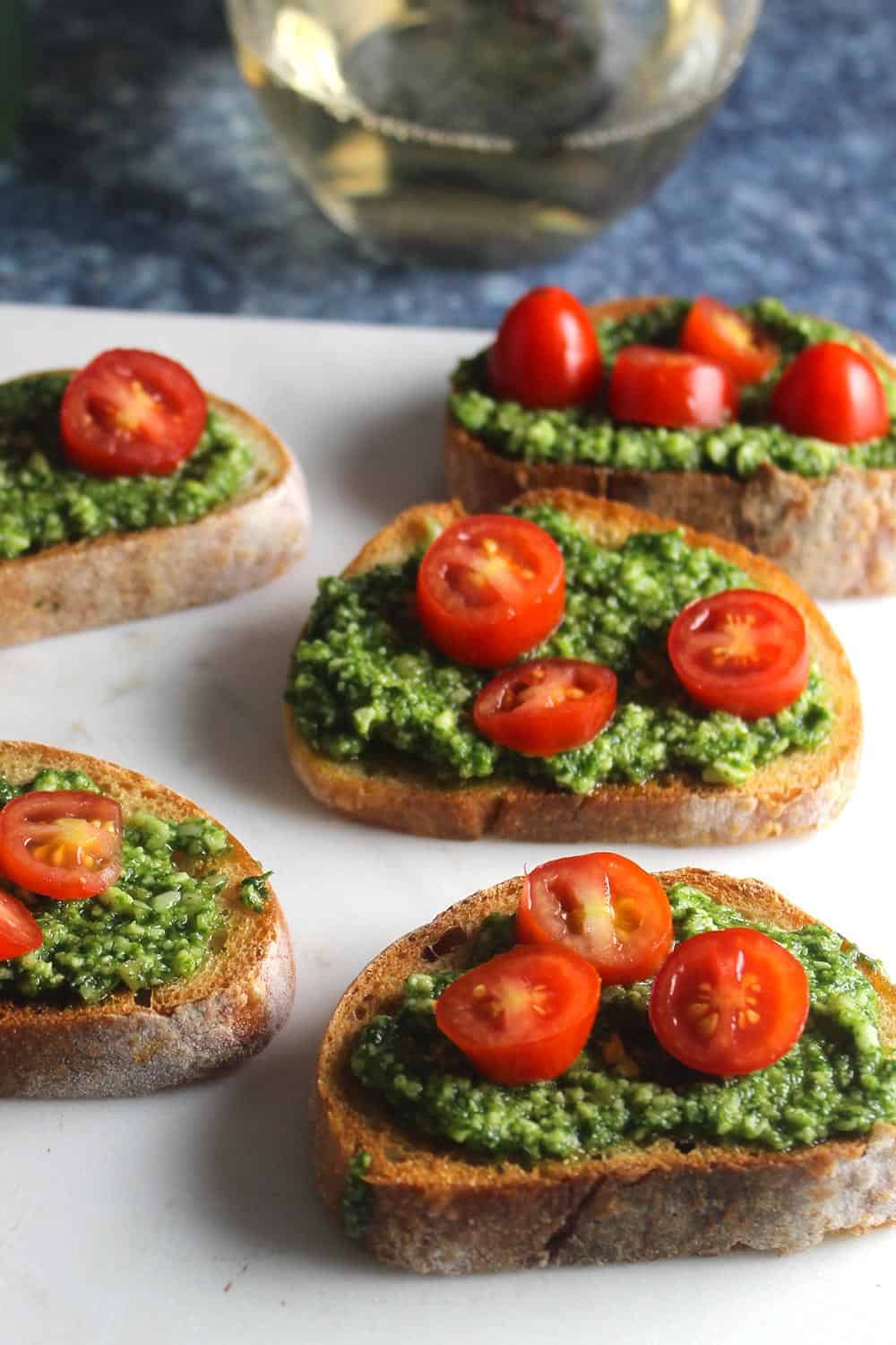 basil pesto crostini served topped with tomatoes