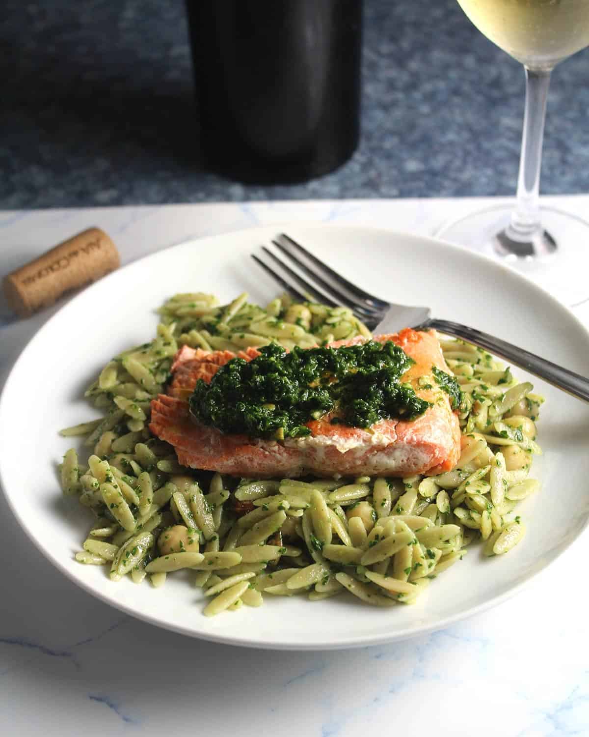 salmon served with pesto and orzo.