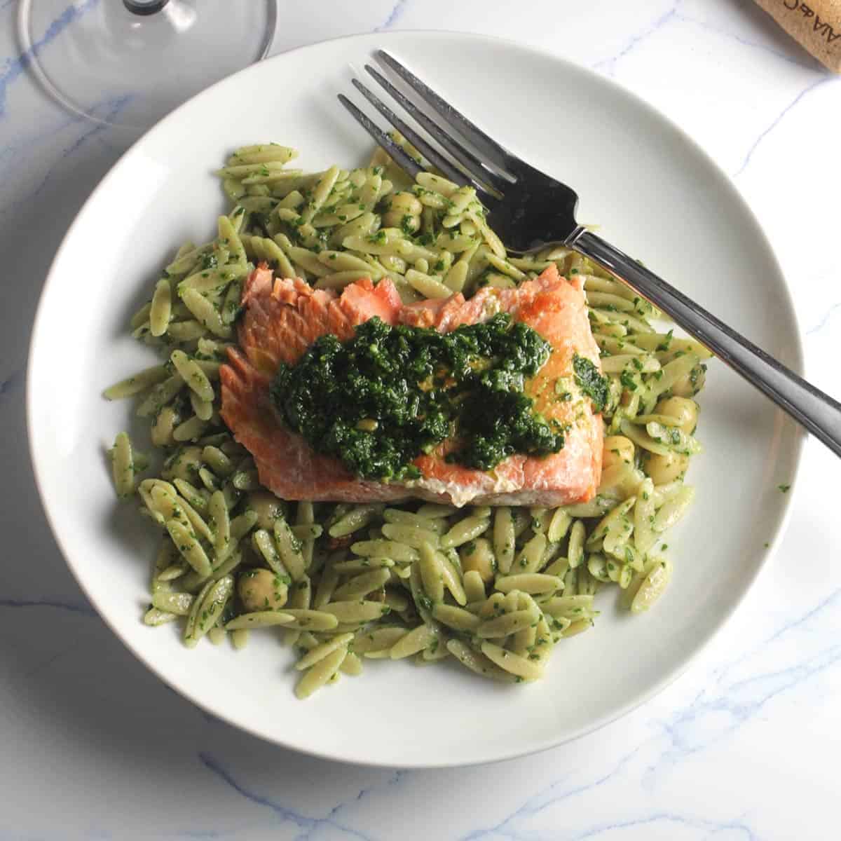 plate of orzo with salmon on top.