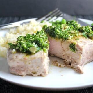 Cilantro Pesto Pork Chops recipe features chops roasted just right in the oven topped with a zesty sauce.