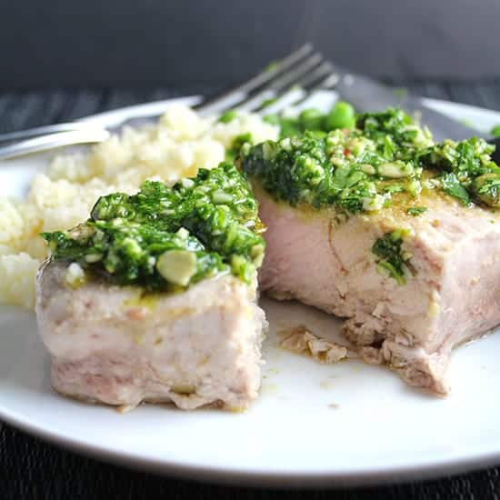 Cilantro Pesto Pork Chops recipe features chops roasted just right in the oven topped with a zesty sauce.