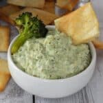 small white bowl with roasted broccoli artichoke dip.
