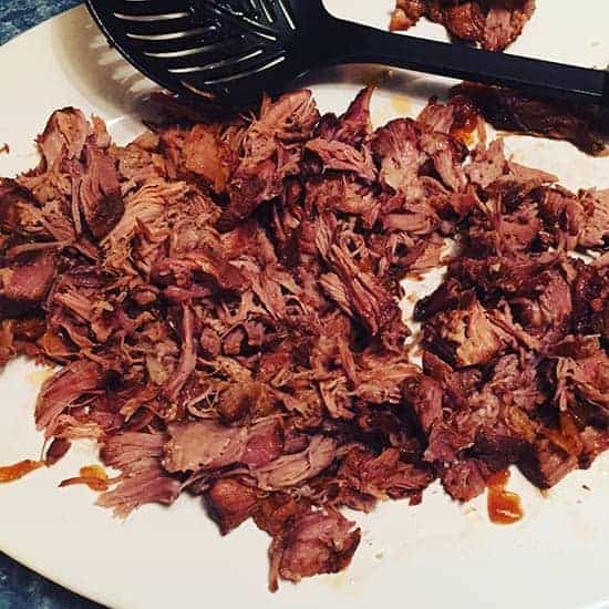 shredding pulled pork from the slow cooker.