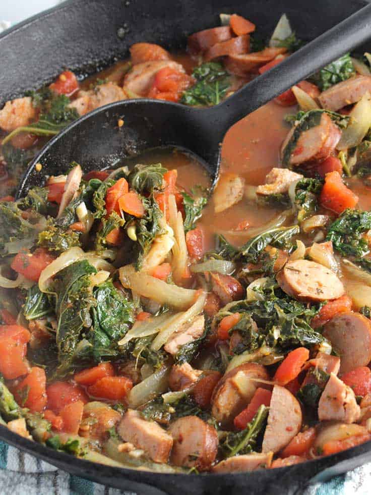 chicken sausage, kale and tomatoes simmer to make a healthy pasta sauce.