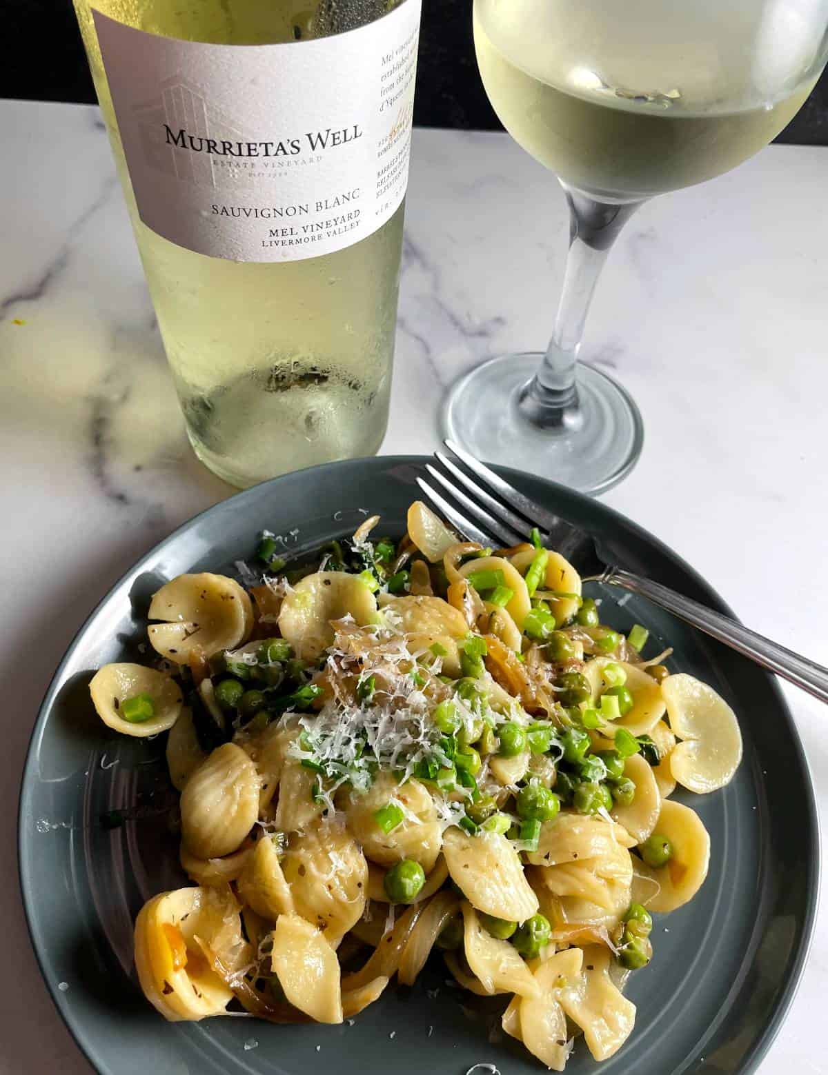 pasta with peas and onions, plated and served with Murrieta's Well Sauvignon Blanc.