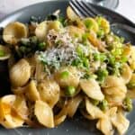 pasta with peas and pecorino on a plate.