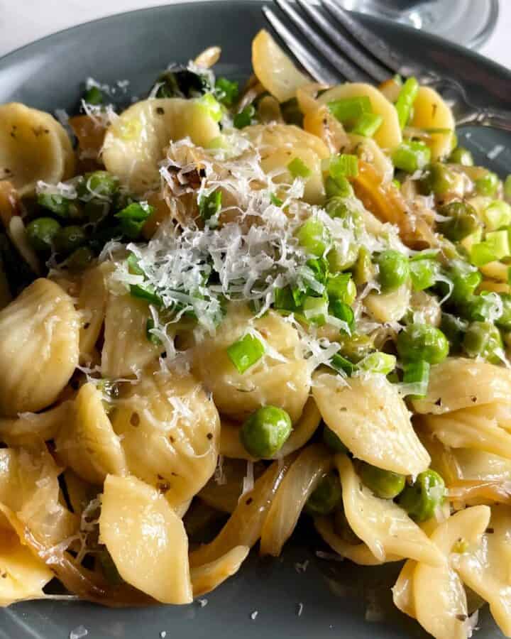 pasta with peas and pecorino on a plate.
