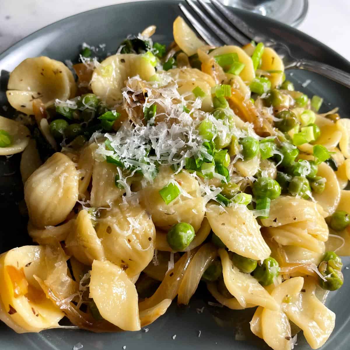 orecchiette pasta with peas, pecorino and onions.