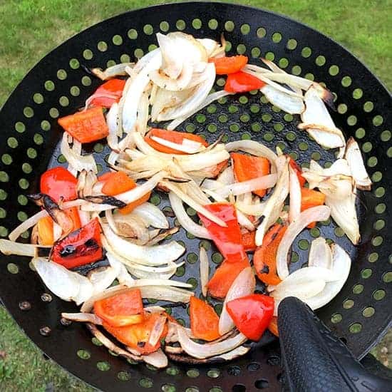 grilled peppers and onions in a grill pan.