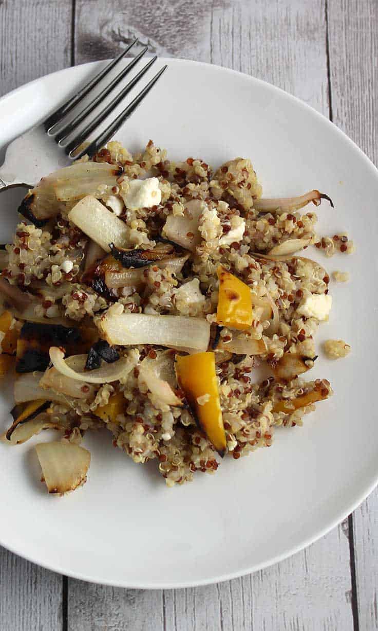 Quinoa tossed with grilled onions, peppers and feta cheese for an easy and hearty side dish. This recipe is perfect to go with grilled meat or fish for a healthy dinner!