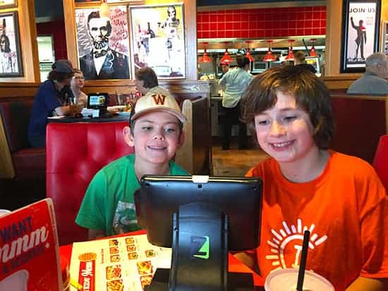 Boys checking out the menu with allergy friendly options at Red Robin.