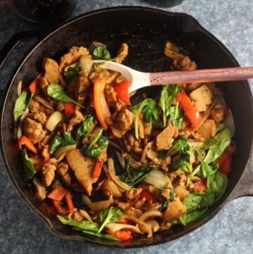 seitan with peppers and onions in a skillet