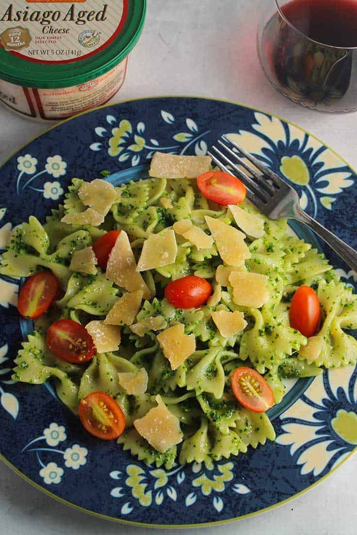 bow tie pasta tossed with kale pesto and Stella asiago cheese, an easy recipe to try for your holiday entertaining. 