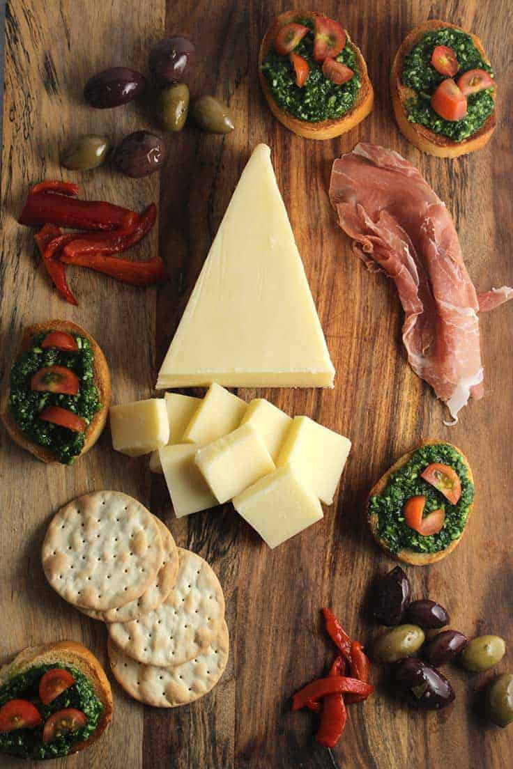 Make an Easy Holiday Cheese Board with @StellaCheese and Kale Pesto Crostini.