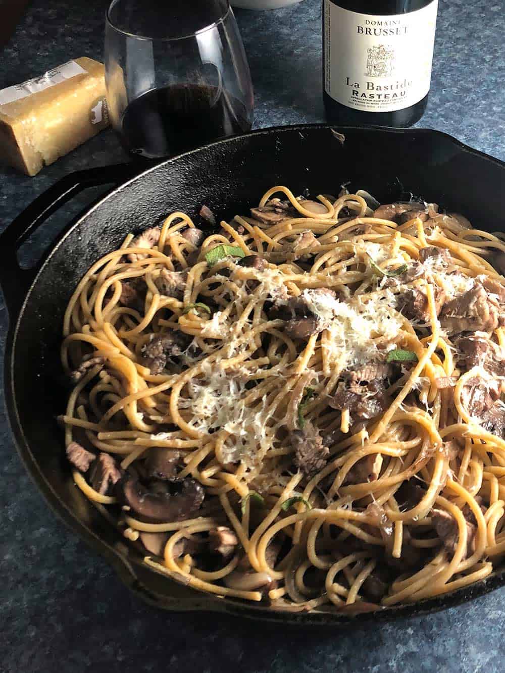 leftover turkey pasta in skillet served with red wine.