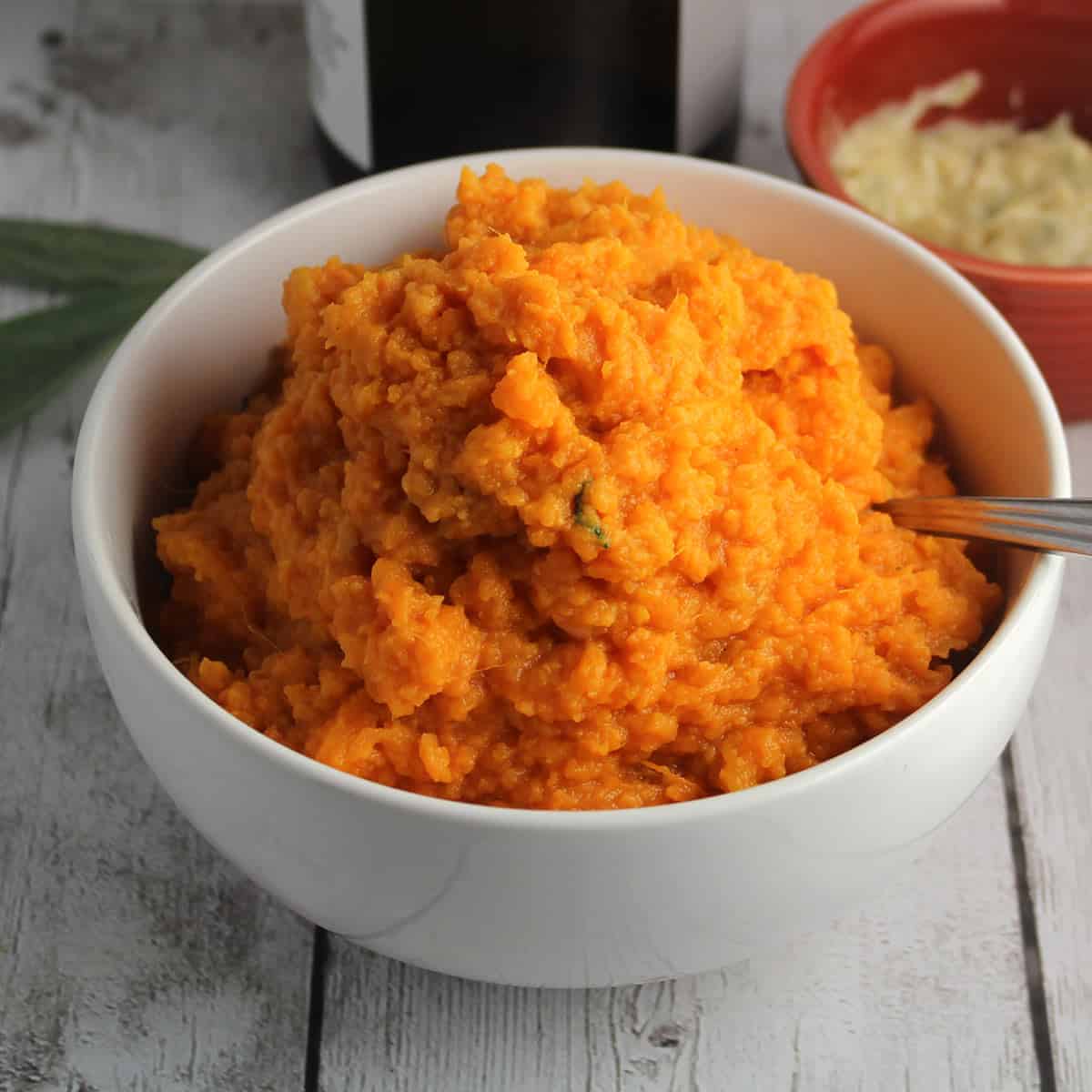 mashed sweet potatoes in a white bowl.