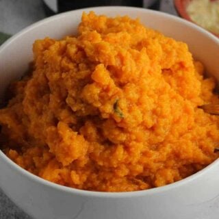mashed sweet potatoes in a white bowl.