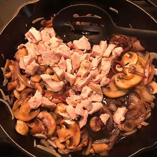 mushrooms and leftover turkey in a skillet