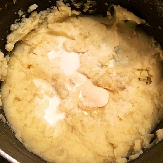 mashing golden potatoes