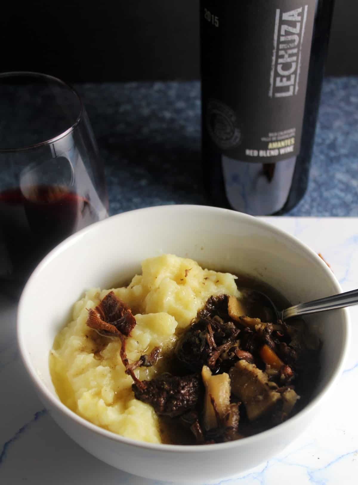 bowl of chanterelle mushroom beef stew paired with red wine