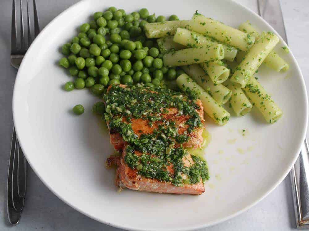 salmon with parsley pesto and a side of peas.