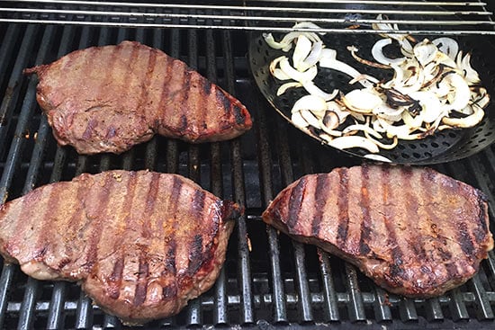 steak and onions on the grill.