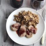 pork tenderloin slices topped with a blackberry Merlot sauce, with a side of farro grain.