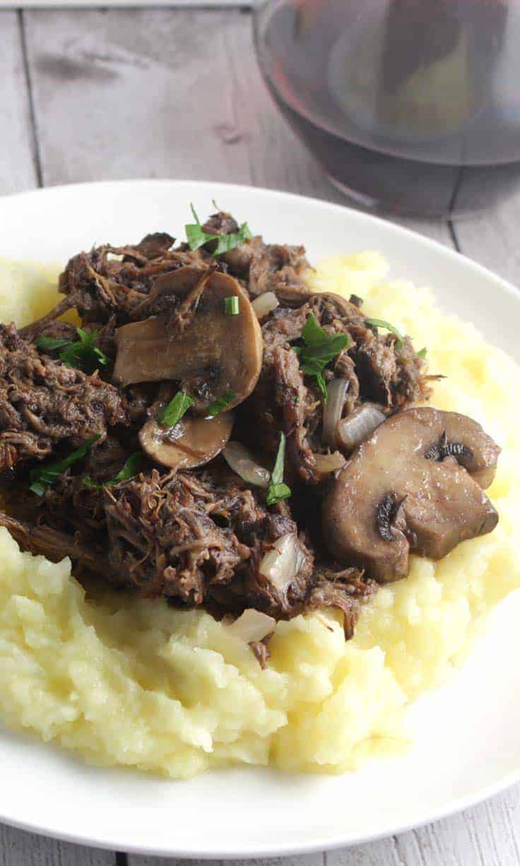 Savory slow cooker short ribs with mushrooms makes for a hearty cold weather meal. #SundaySupper #slowcooker