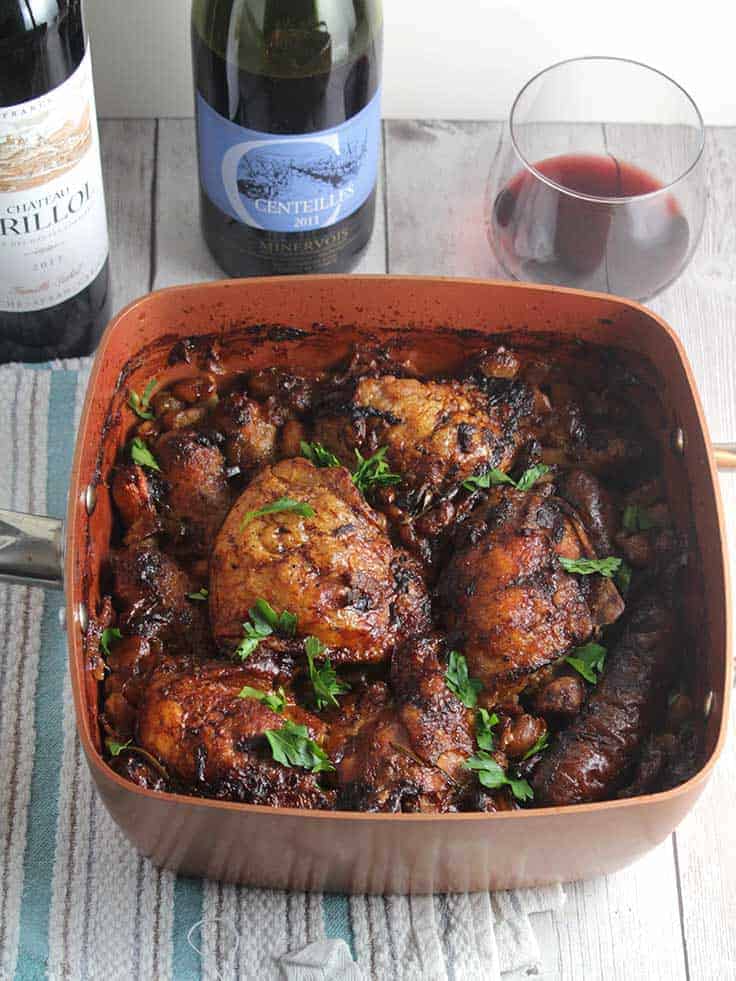 chicken cassoulet in a pan, served with red wine