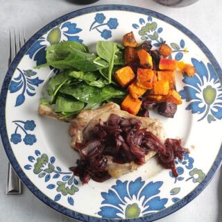 pork chops topped with pomegranate sauce, served with roasted beets, butternut squash and spinach salad.