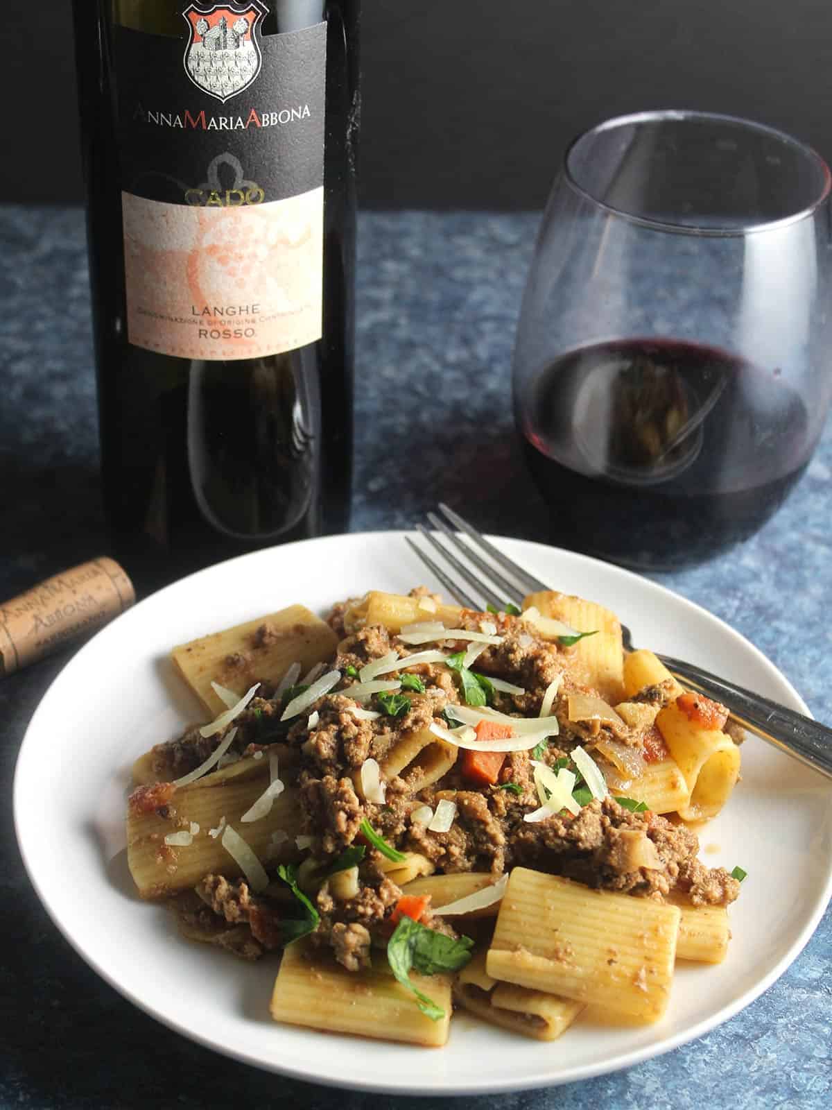 bolognese pasta served with red wine.