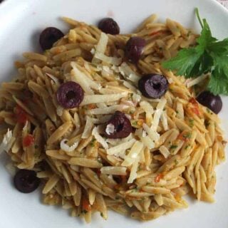 plate with orzo topped with provencal pesto and olives.