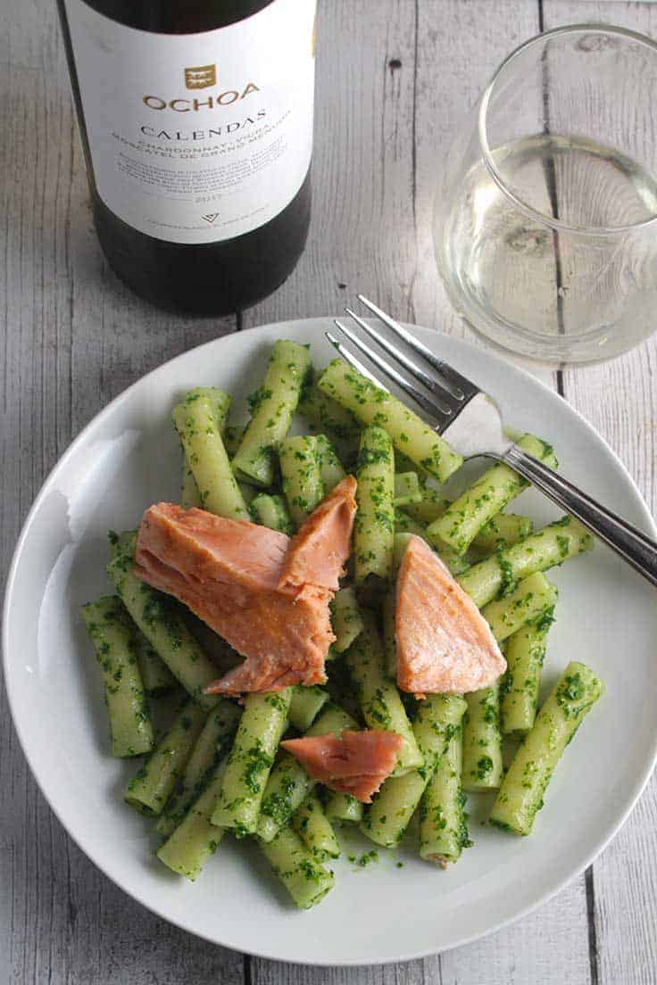 plate of pasta with pesto and salmon