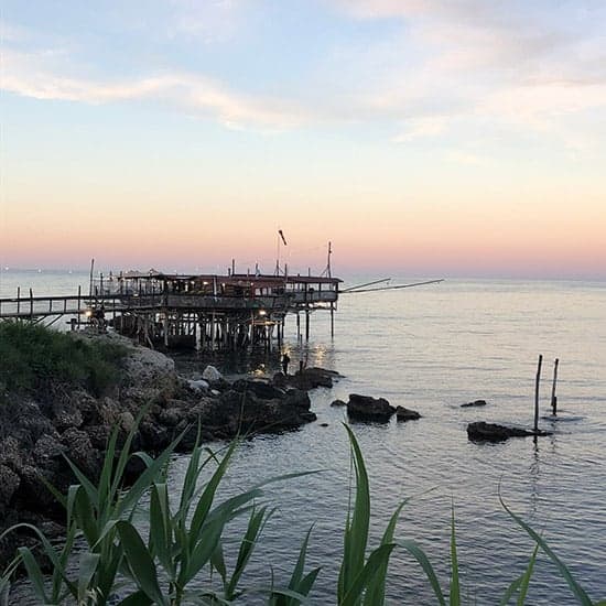 sunset behind a trabocco in Abruzzo, Italy.