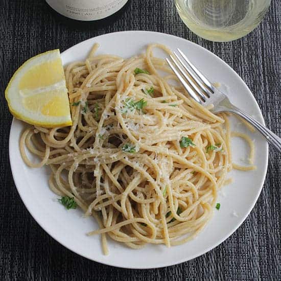 plate with spaghetti tossed with lemon juice and Asiago cheese.