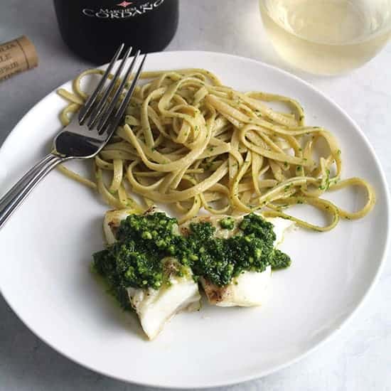 grilled halibut topped with kale pesto and a side of linguine.