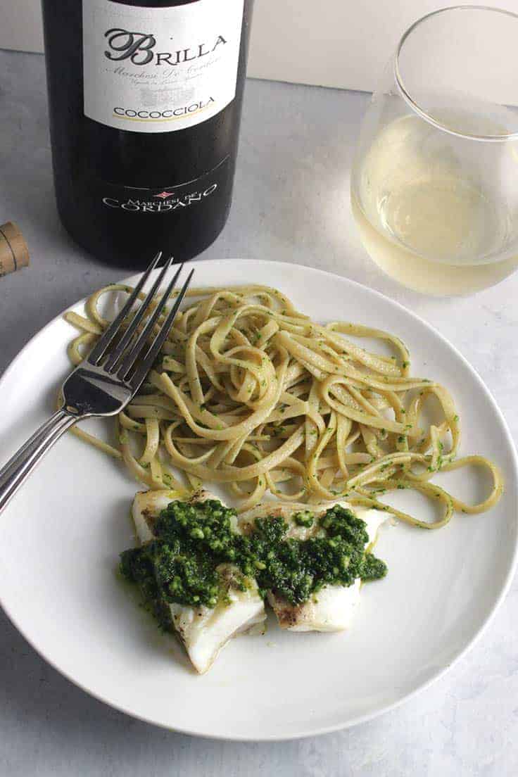 grilled halibut with kale pesto, served with a white wine.