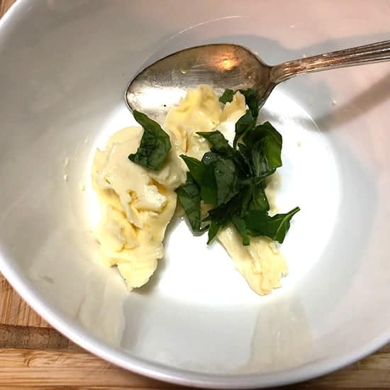 making garlic butter with basil