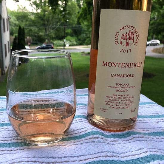 glass of Montenidoli Rosato next to the bottle of wine.
