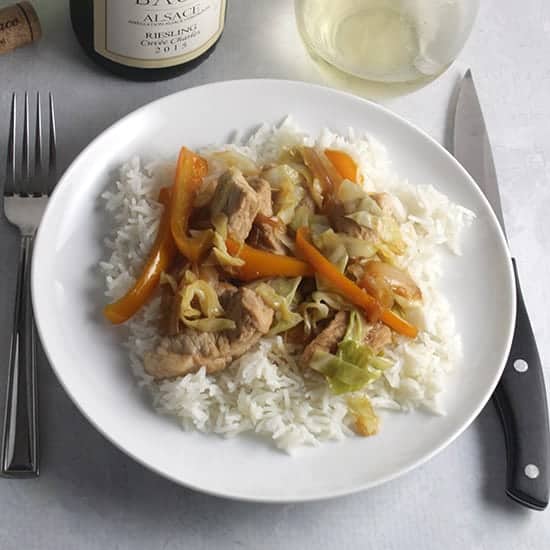 pork and cabbage skillet served with a Riesling.