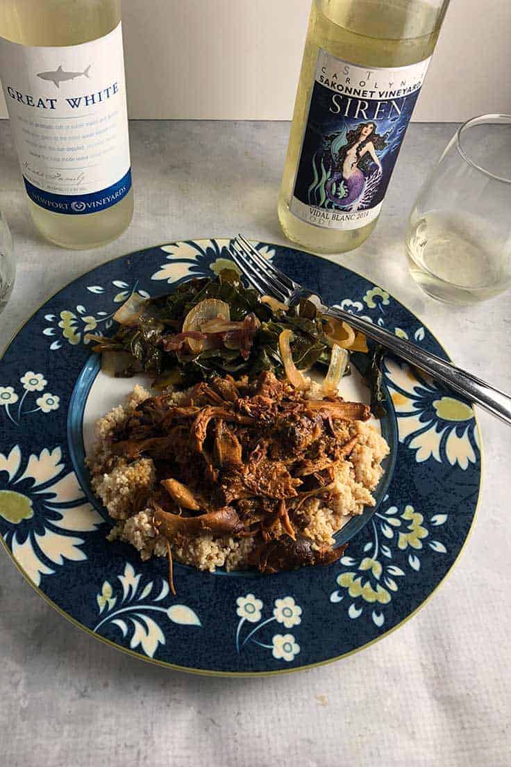 honey mustard chicken thighs on a plate with wine.