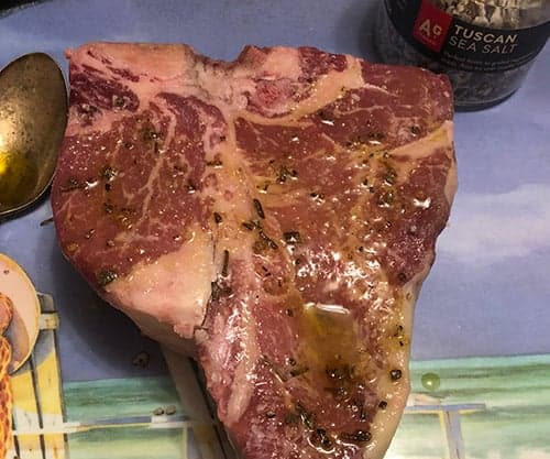 preparing porterhouse steak to make Bistecca alla Fiorentina